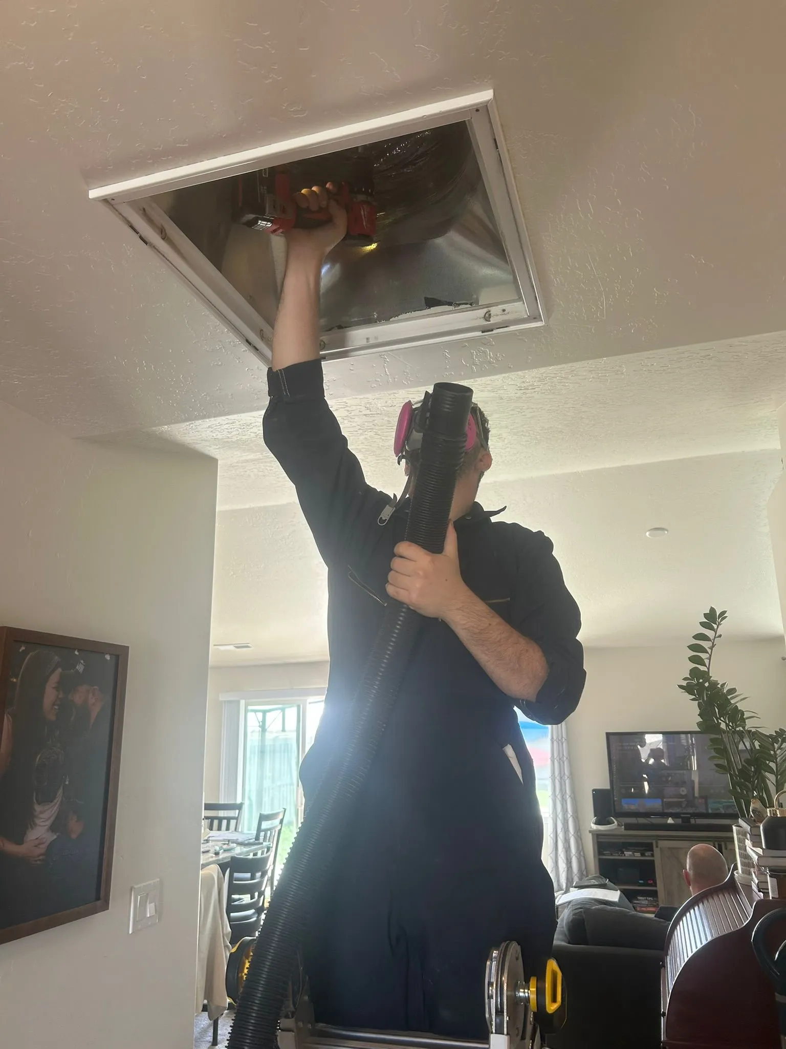 Apex technician cleaning an air duct vent in Boise ID